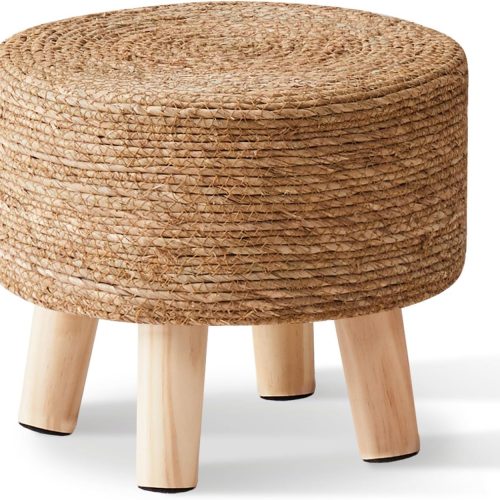 Natural seagrass hand-woven pouf ottoman, soft padded foot rest with non-skid pine legs, for hallway office lounge.