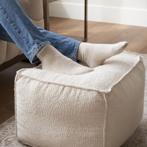 Round modern pouf ottoman, boucle upholstered, lightweight foam filled, foot rest for living room decor.